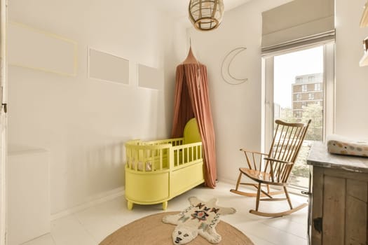 a baby's room with a rocking chair, cribt and other items on the floor in it