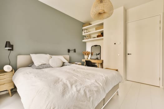 a bedroom with a bed, dresser and lamp on the wall behind it is an open white door that leads to another room