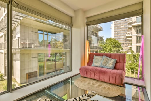 a living room with a pink couch and zebra rugs on the floor in front of the window looking out