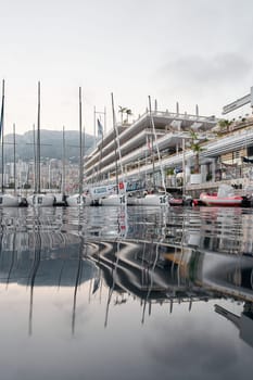 Monaco, Monte-Carlo, 18 October 2022: A lot of sailing boats are moored in new Yacht Club at the world championship of J70 class at sunset, port Hercules. High quality photo