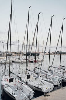 Monaco, Monte-Carlo, 18 October 2022: A lot of sailing boats are moored in new Yacht Club at the world championship of J70 class at sunset, port Hercules. High quality photo