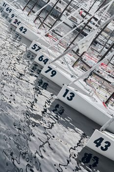 Monaco, Monte-Carlo, 18 October 2022: A lot of sailing boats are moored in new Yacht Club at the world championship of J70 class at sunset, port Hercules. High quality photo