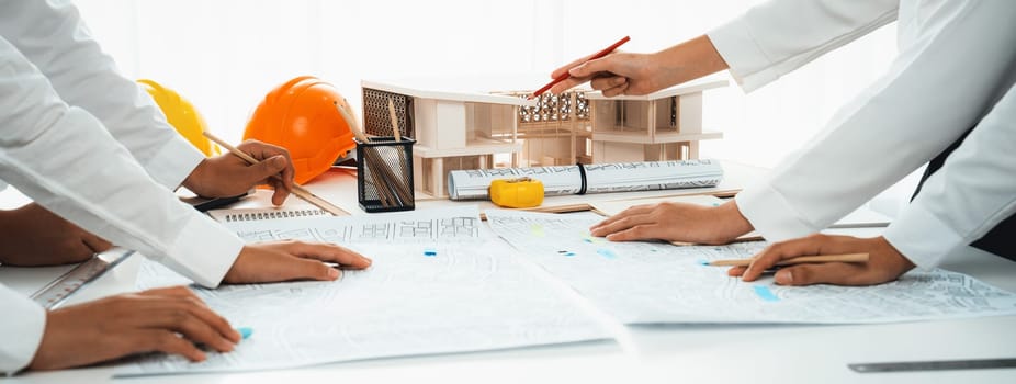 Worker, architect and engineer work on real estate construction project oratory planning with cartography and cadastral map of urban town area to guide to construction developer business plan of city