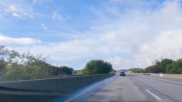 Los Angeles, California, USA-December 4, 2022-POV-Driving on HWY 101 near Santa Barbara, California, the road is shrouded in cloudiness during winter, creating a moody atmosphere while still showcasing the beauty of the coastal landscape.