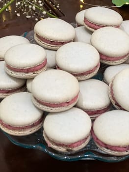 Silver French macarons in various flavors made to look extra fancy at a wedding reception dessert buffet.