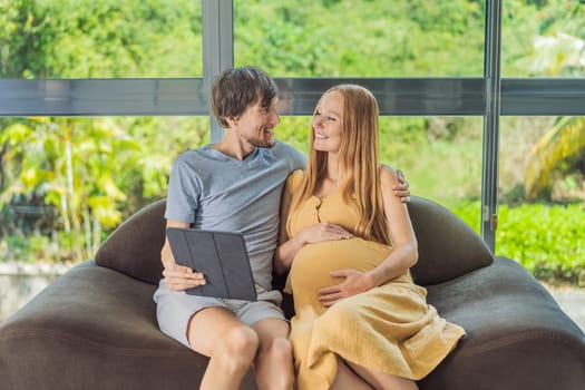 A smiling husband and his pregnant wife share a moment of joy, gazing at a tablet screen, their faces glowing with anticipation and happiness.