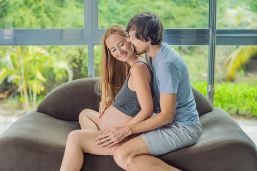 health, pregnancy and happy people concept - husband giving his wife back massage at home.