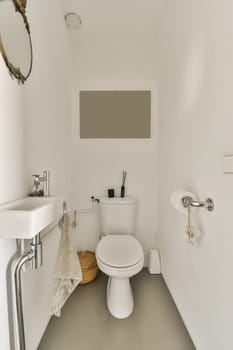a bathroom with a toilet, sink and towel hanging on the wall next to it is a mirror in the corner