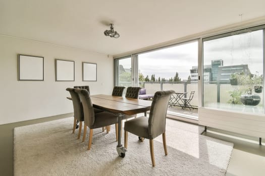 a dining room with a table and chairs in front of large windows looking out onto the cityscapea