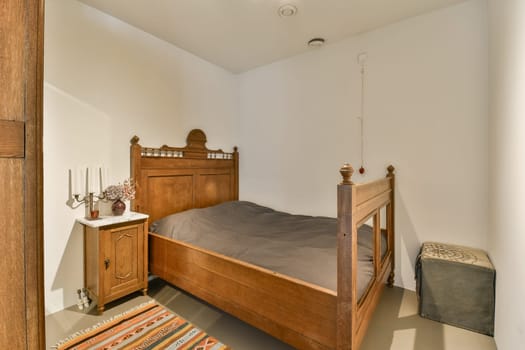 a bedroom with a bed, dresser and mirror on the wall in front of the bed is an old wooden door