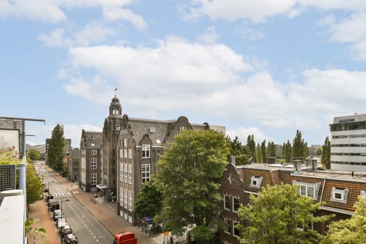 a city with buildings, cars and trucks on the street in front of thema houses that are surrounded by trees