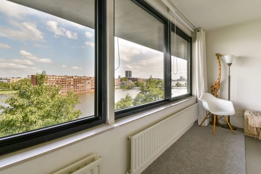 a room with a view of the water and buildings from it's window simn, taken from inside