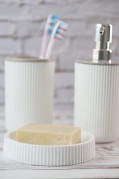 bathroom soap dispenser and toothbrush cup.