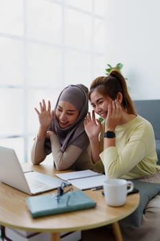 Muslim undergraduates and Asian women are studying online using computers