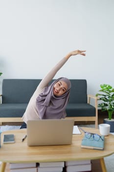 Muslim undergraduate students relax their muscles after taking online e-learning via computer system