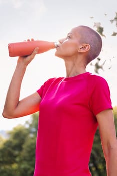 portrait of a woman drinking water during her training, concept of sport in nature and healthy lifestyle