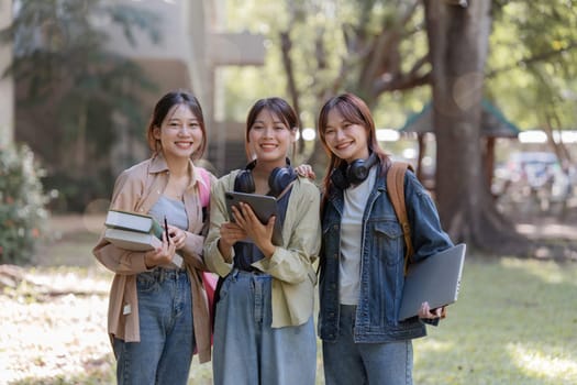 university students using a digital tablet while walking to next class.