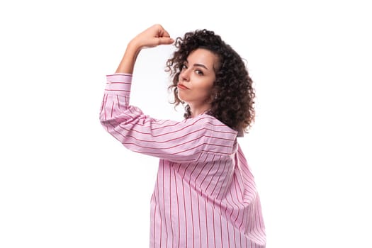 confident young office secretary woman dressed in a striped pink shirt on a white background.