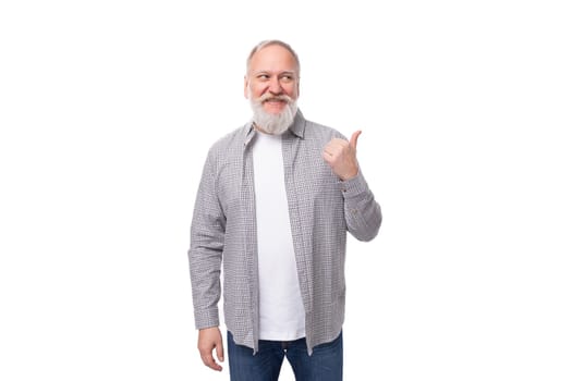 handsome retired man with a beard and a big mustache is dressed in a shirt and jeans.