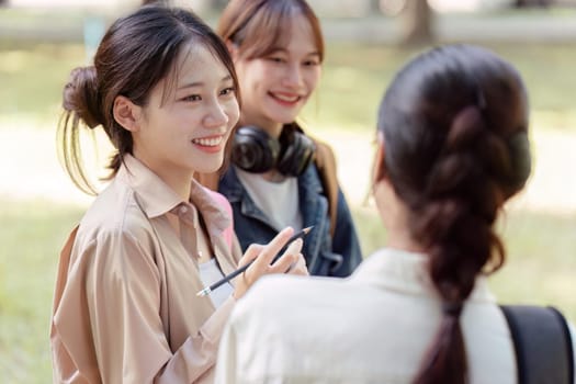 university students using a digital tablet while walking to next class.