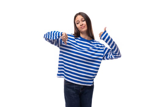 young fashionista brunette woman dressed in a stylish cotton blue blouse on a white background with copy space.