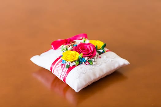 Small decorative pillow with many coloured flowers