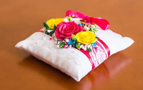 Small decorative pillow with many coloured flowers