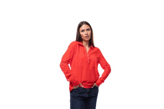 young well-groomed brunette employee woman dressed in a red loose shirt on a white background.