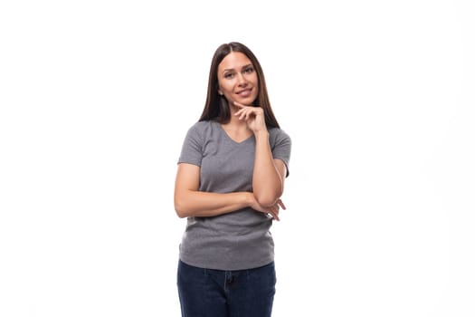 young slim brunette promoter woman dressed in a gray basic t-shirt with print mockup. uniform concept.