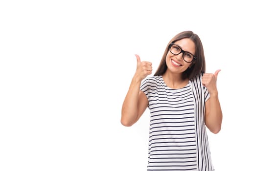 young european brunette woman in a striped sweater wears glasses for vision correction on a white background with copy space.