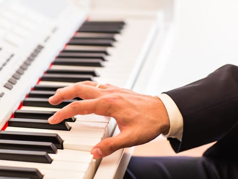 Hands of musician. Pianist playing on electric piano