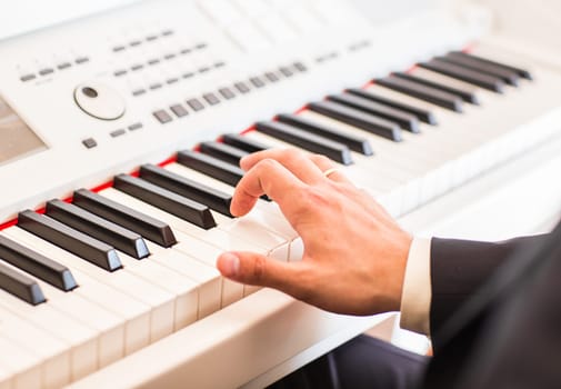 Hands of musician. Pianist playing on electric piano