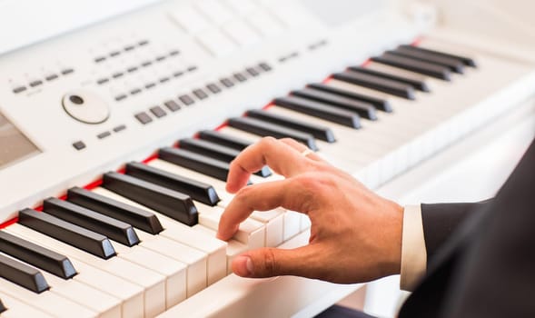 Hands of musician. Pianist playing on electric piano