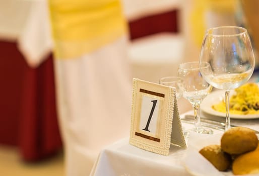 sign on restaurant table with empty dishes and glasses.