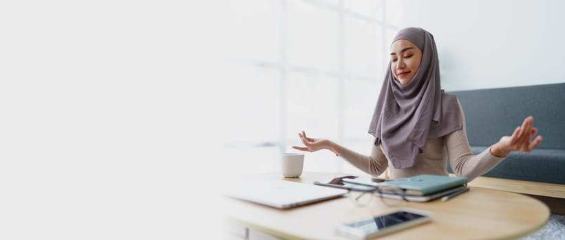 Muslim female employee Meditate while working in the office