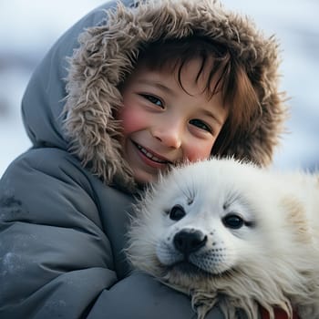 Portrait of a kid with a harp seal pup cuddling in cold polar place.