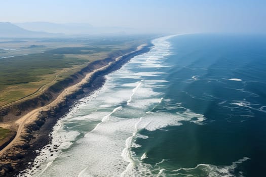 A long sea spit along the shore with white waves.