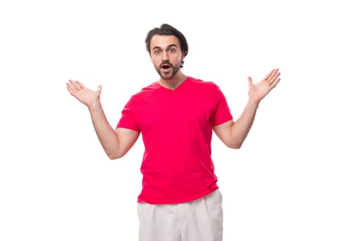 young surprised male promoter dressed in a red basic t-shirt. corporate clothing color.