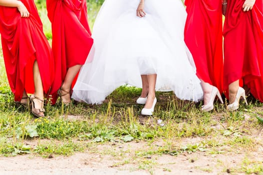 Bride and bridesmaids show off their shoes at wedding