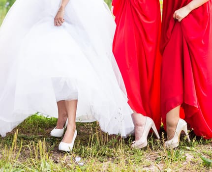 Bride and bridesmaids show off their shoes at wedding