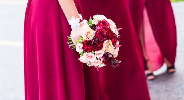 close up of woman hands with bouquet of flowers