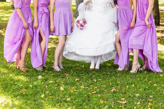 Bride and bridesmaids show off their shoes at wedding