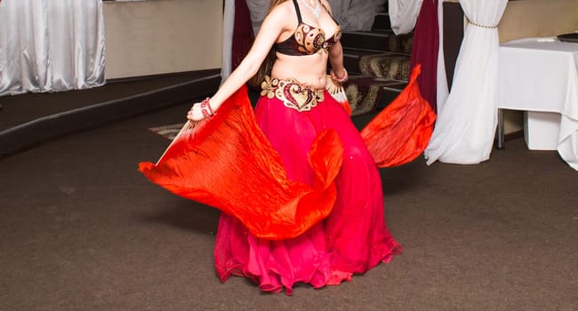 Beautiful exotic belly dancer woman. Red dance costume