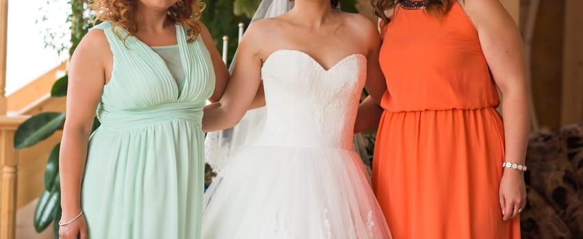 Bride with bridesmaids indoors on the wedding day