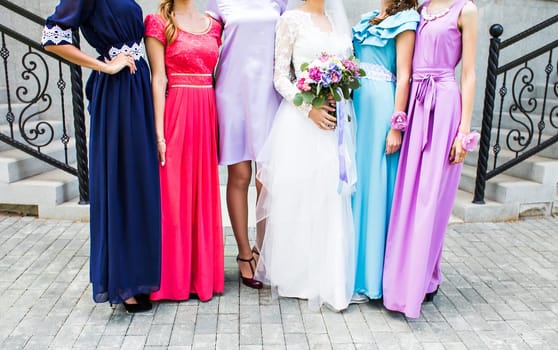 Bride with bridesmaids on the park on the wedding day