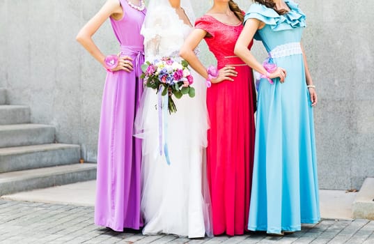 Bride with bridesmaids on the park on the wedding day