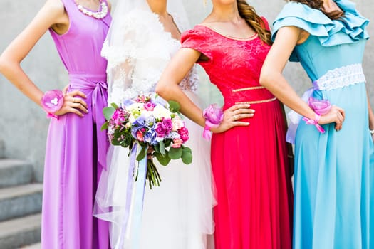 Bride with bridesmaids on the park on the wedding day