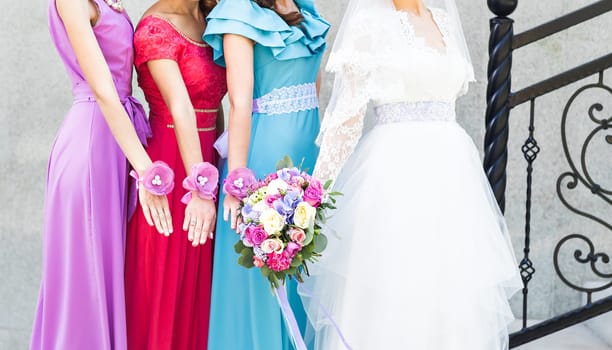 Bride with bridesmaids on the park on the wedding day