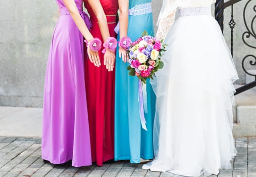 Bride with bridesmaids on the park on the wedding day