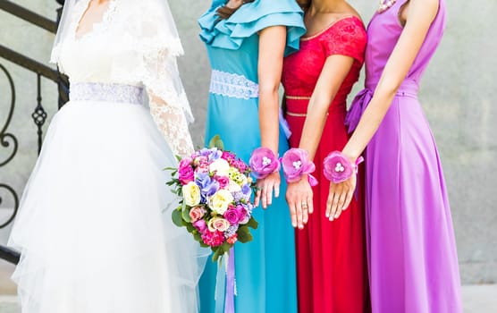 Bride with bridesmaids on the park on the wedding day